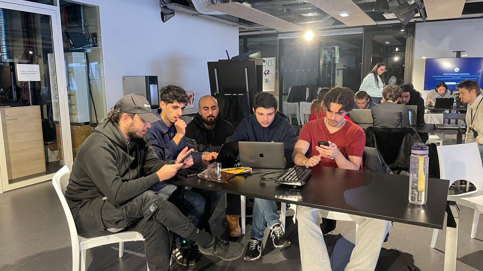 Builders collaborating around laptops during a workshop