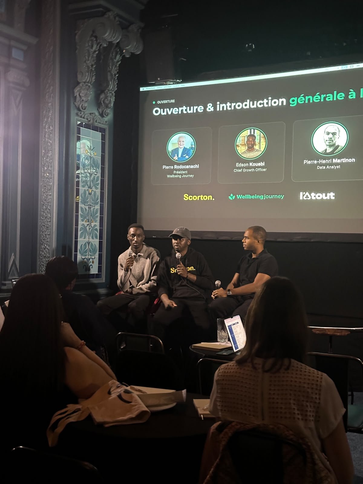 Three speakers discussing AI on stage